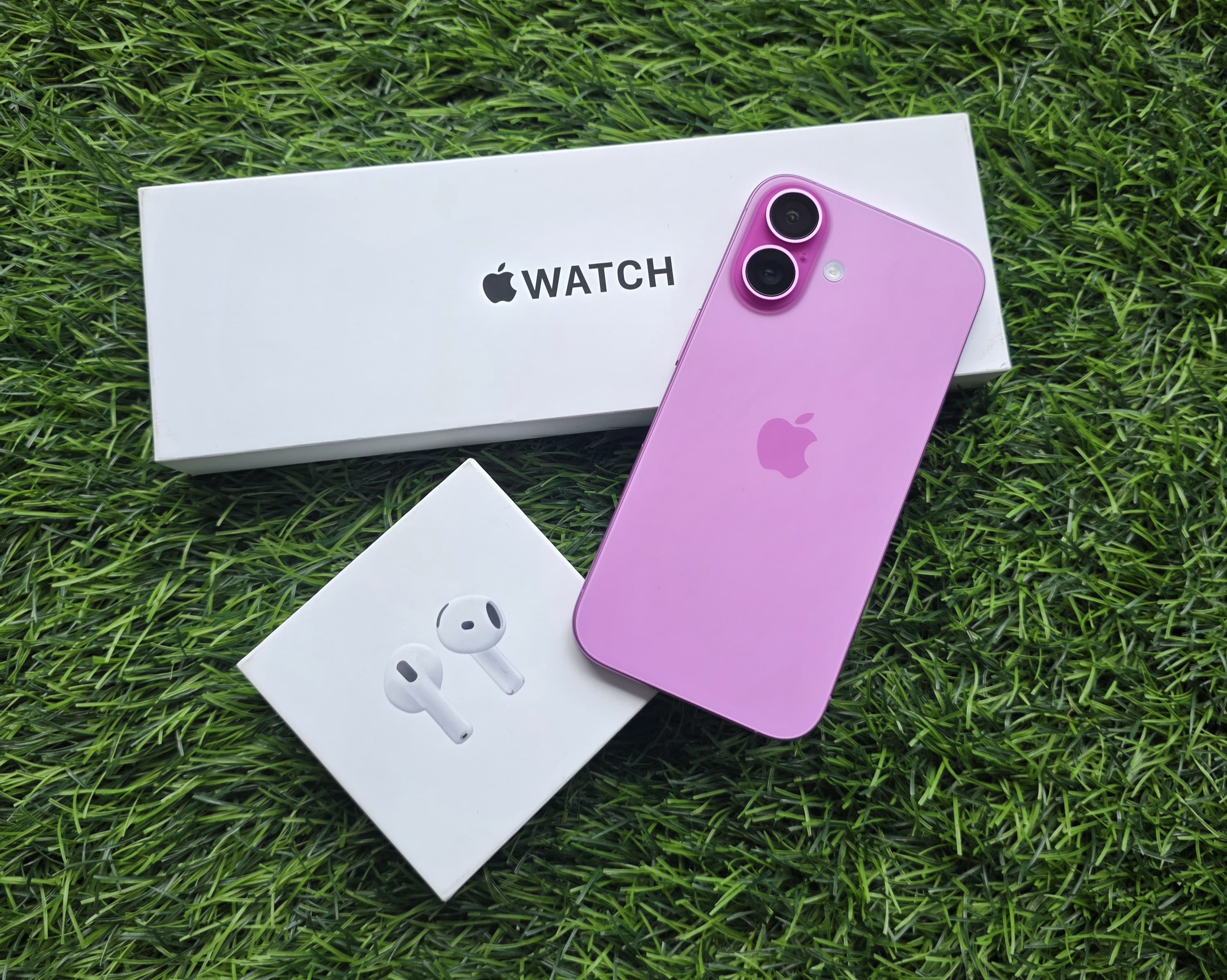 Apple Watch, pink iPhone and AirPods photo at The Source Arena JA.